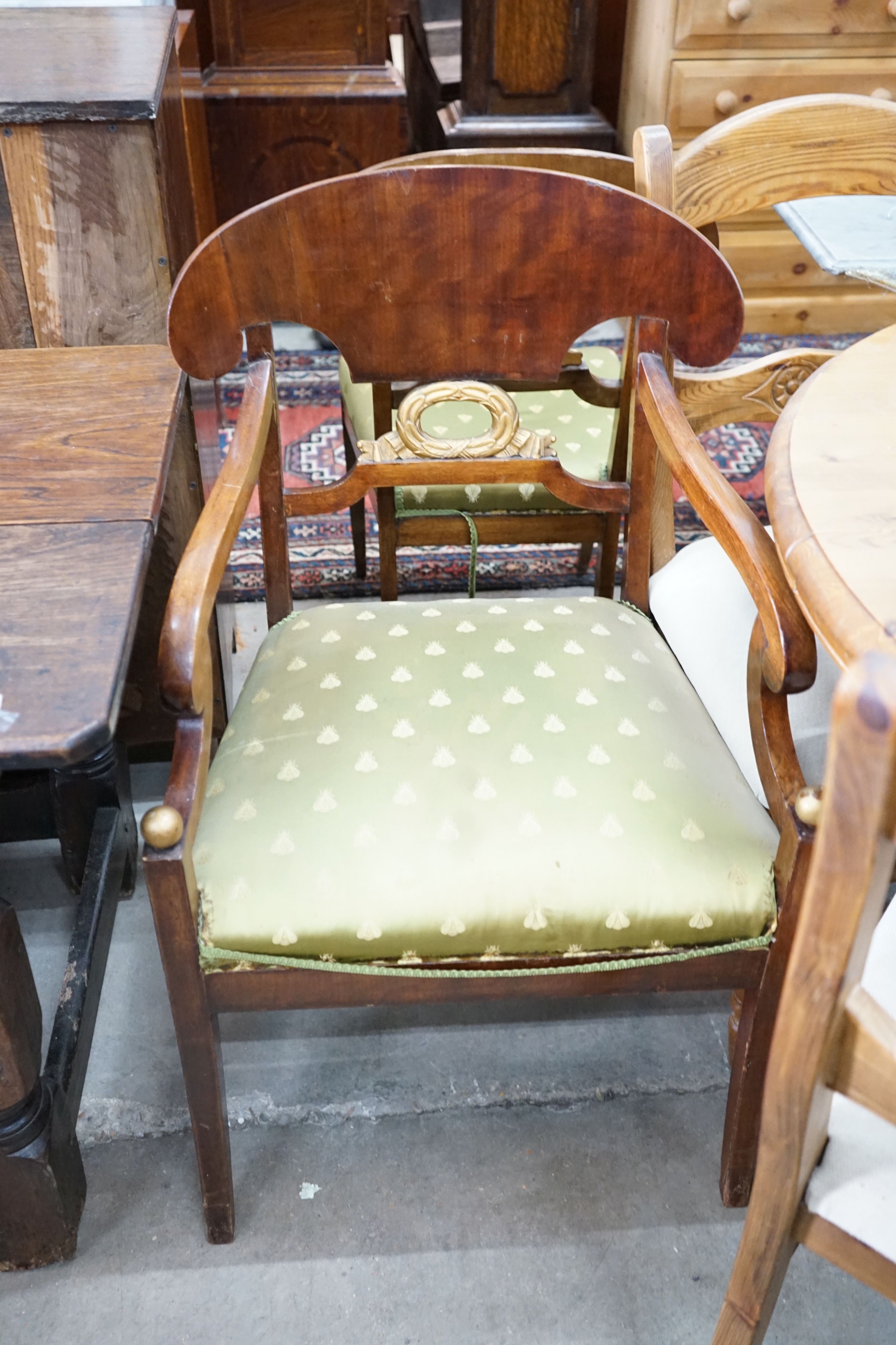 A set of eight Swedish Biedermeier birch with mahogany veneer, wreath design dining room chairs, including two carvers, mid 19th century